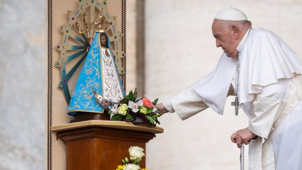 Pope Francis touches a statue of Our Lady of Lujan, during the weekly general audience on May 8, 2024 at St Peter's square in The Vatican.